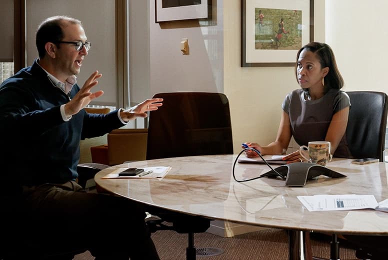 Professionals reviewing workforce and organizational documents in a structured presentation setting